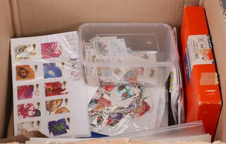 A quantity of world stamps, some on paper, some loose