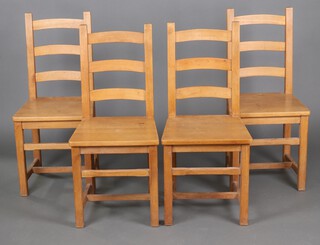 A set of 4 beech framed ladder back dining chairs with solid seats on square supports with H framed stretchers 98cm h x 45cm w x 40cm d 