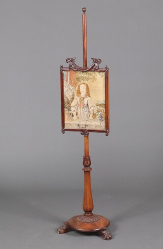 A Victorian rosewood pole screen with rectangular Berlin wool work panel decorated a girl, raised on a turned column with circular base and paw feet 142cm h (a/f)