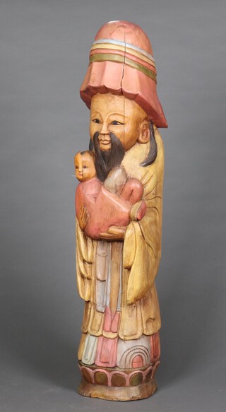 A Chinese carved figure of a standing gentleman with baby 107cm h x 24cm (split to figure)