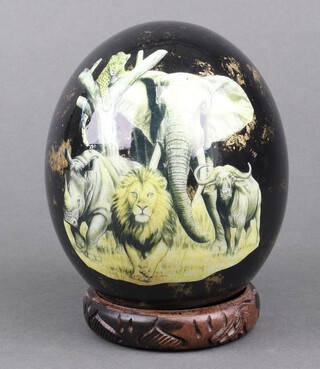 An ostrich egg decorated with a map of Africa and wild animals