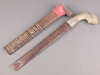 An Eastern dagger with 32cm blade, horn grip and wooden scabbard 