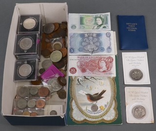 A collection of British coins, crowns and bank notes