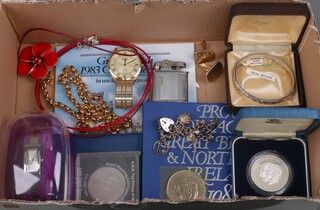 A silver charm bracelet, an enamelled poppy, etc together with a collection of commemorative crowns, coins, watches etc