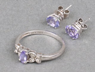 A silver gem set ring and a pair of matching ear studs