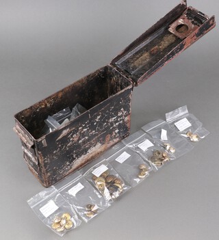 An ammunition box containing a quantity of modern Army badges