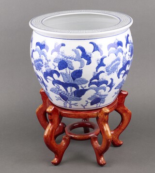 A Chinese blue and white jardiniere raised on a hardwood base 43cm 