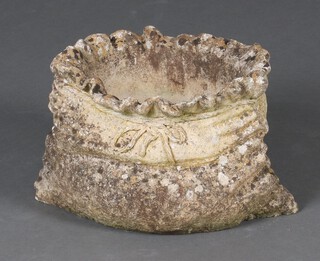 A well weathered oval garden planter in the form of a tied sack 22cm x 29cm x 25cm 