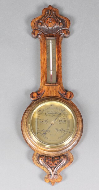 Dolland of London, an aneroid barometer with gilt dial, contained in a carved oak case 70cm x 23cm 