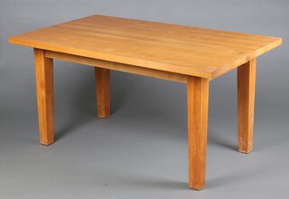 A rectangular oak dining table raised on squared supports 75cm h x 150cm l x 89cm w