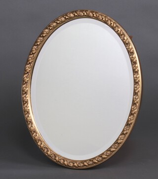 An oval bevelled plate wall mirror contained in a decorative gilt frame 49cm x 40cm 