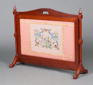 An Edwardian arched and carved mahogany fire screen with Berlin woolwork panel to the centre 72cm h x 91cm x 28cm 