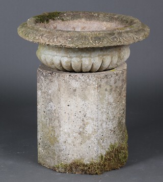 A well weathered concrete garden planter with lobed border on an associated octagonal base 64cm h x 55cm 