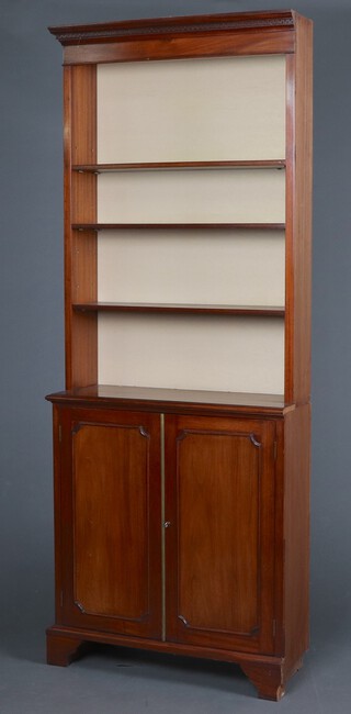 A section of reproduction mahogany bookcase with moulded cornice, fitted adjustable shelves, the base enclosed by a panelled door, on bracket feet 208cm h x 82cm w x 29cm d (1 section unfinished)