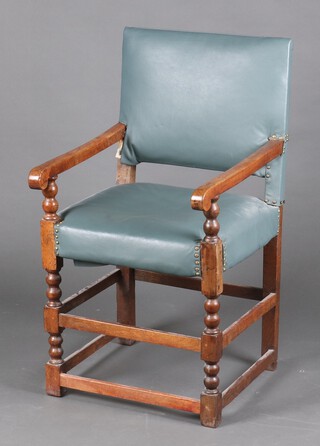 An oak framed open arm chair upholstered in blue material, raised on turned and block supports 99cm h x 53cm w x 56cm d 