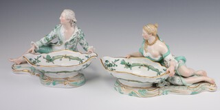 A pair of 19th Century Meissen sweet meat dishes in the form of a lady and gentleman reclining beside a shallow dish decorated with dragons on Rococo bases, the bases with blue cross sword marks and impressed numbers 2858 40 and 2863 31.5cm 