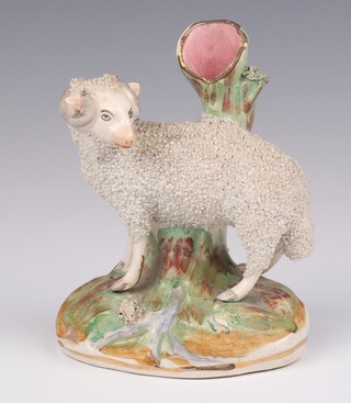 A Victorian Staffordshire spill vase in the form of a standing ram on a rocky base 14cm 