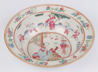 A late 19th Century Chinese circular deep bowl decorated with a mother and child within a pavilion enclosed by a band of figures and flowers 29cm 