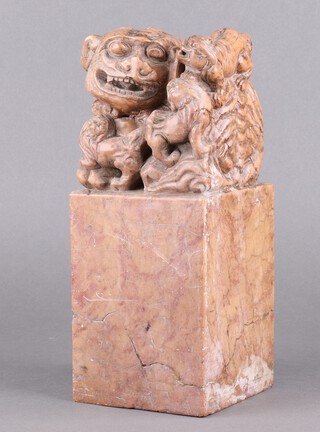 An impressive Chinese carved soapstone seal in the form of a Shi Shi and pups with 4 character mark to base 32cm 