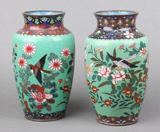 A pair of 19th Century Chinese green ground and floral patterned cloisonne vases decorated birds amidst branches 25cm x 9cm 