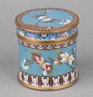 A Chinese blue ground and floral patterned cloisonne enamelled jar and cover of cylindrical form 9cm x 9cm 