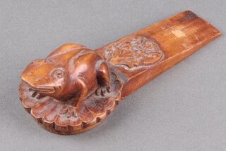 A Chinese carved hardwood door wedge decorated a seated frog on leaf 6cm x 19cm x 7cm 