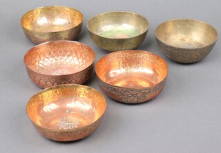 A Japanese circular polished bronze bowl decorated a dragon 6cm x 12cm, 1 other and 4 circular embossed bowls with flower head decoration 4cm x 12cm 