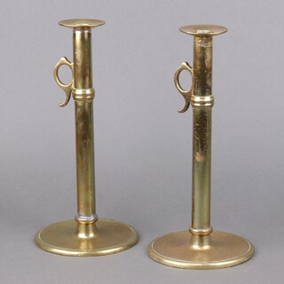 A pair of 19th Century brass candlesticks with side ejectors, on circular bases 30cm h x 14cm 
