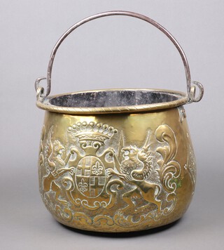 A Dutch embossed brass coal bin decorated a coat of arms and fleur de lys with iron handle and later liner 28cm h x 35cm diam, 
