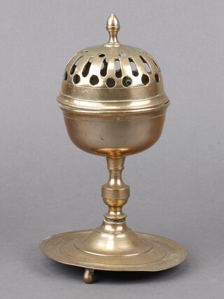 A circular Eastern brass censor with hinged lid, on a circular base with 3 bun feet 23cm x 14cm 