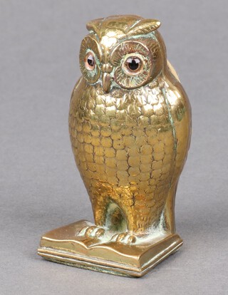 A Victorian pin cushion in the form of a seated owl with hardstone eyes, on a book 8cm x 4cm x 4cm 