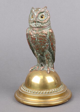 A Victorian brass and copper inkwell in the form of a seated owl with hardstone eyes, raised on a brass base in the shape of a dome 23cm x 14cm 