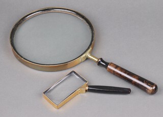 A late 19th/early 20th Century large magnifying glass with brass frame and ebonised turned handle 23cm, together with a rectangular brass cased ditto 10cm 