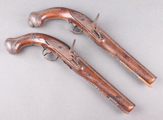 A pair of 18th Century Continental flintlock pistols with 22cm steel barrels, the trigger guards with crescent moon 