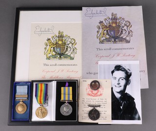 A family group of father and son medals comprising British War medal and Victory medal to T-289567 Driver J Pentroy Army Service Corps together with an associated discharge badge no. B43016 (pin broker) and a posthumous pair Korea medal and United Nations Korea medal to 1903409 Corporal J W Pentroy Middlesex Regt., together with a posthumous medal certificate numbered 7F536 A, an Elizabeth Cross memorial scroll, an Elizabeth Cross box (empty) and a photograph of the recipient 
