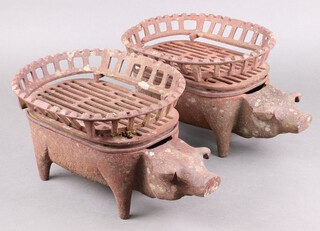 A pair of cast iron garden griddles in the form of standing pigs 20cm h x 44cm w x 27cm d 