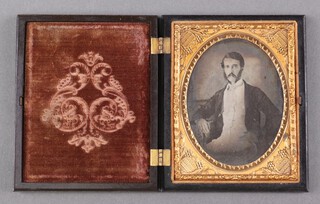 A Victorian oval ambrotype of a seated gentleman in a composition case, 9.5cm x 7cm 