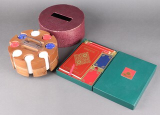 A turned wooden revolving game counter bank, containing 300 various coloured plastic gaming counters, together with a David Westnedge boxed bridge set comprising 2 sets of bridge cards, 3 pencils and 4 score books (used)