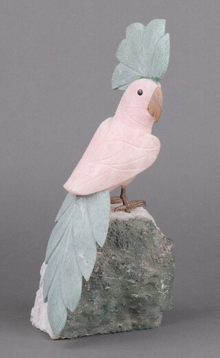 A carved hardstone figure of a seated cockatoo on a rocky outcrop 30cm x 14cm x 7cm 