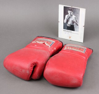 Barry Mcguigan, a signed photograph 20cm x 11cm, together with a pair of red Lonsdale boxing gloves