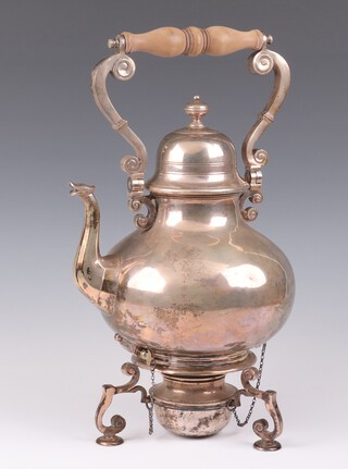 A silver Queen Anne style bulbous tea kettle on stand with burner, having a turned wood handle and knop finial, raised on scroll feet, 39cm to the handle, London 1929, maker Francis Higgins and Son Ltd, gross weight 2972 grams 