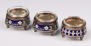 Three Continental silver and enamelled table salts, 2 decorated with a band of flowers, 1 with polka dots, all with clear glass liners, 94 grams, 5cm