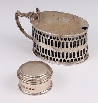 A Victorian silver oval mustard with pierced decoration Birmingham 1900, maker Thomas Hayes, 126 grams together with a 925 standard circular pill box Sheffield 2014