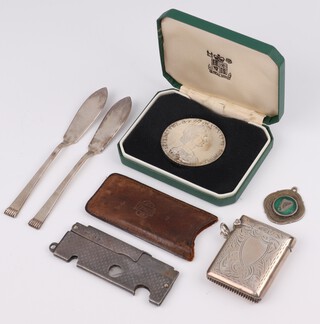 A silver vesta engraved with vacant cartouche Birmingham 1916, 2 butter knives, a National Trust silver coin, a silver mounted cigar cutter and fob, weighable silver 79.2 grams 