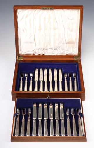 A set of 12 silver bladed and silver handled fruit knives and forks, Sheffield 1939, maker Harrison Brothers and Howson, contained in a mahogany case, plaque missing