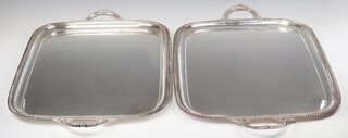 A pair of rounded rectangular silver plated 2 handled trays by Walker and Hall 71cm 