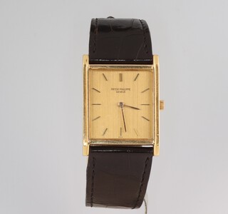PATEK PHILIPPE,  a gentleman's 18ct yellow gold rectangular wristwatch contained in a 26mm x 33mm case, the movement numbered 1145873 23-300, the case numbered 2670758 3519 movement stamped Patek.Philippe and Co. with a leather strap and 18ct yellow gold clasp, the case engraved TMP 1967