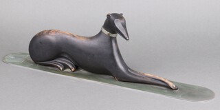 Franz Hagenauer (Austrian 1906-1986), a carved wooden figure of a reclining hound with metal collar, raised on a steel base, impressed marks Atelier Hagenauer Wien, stamped WHW, Made in Vienna Austria, 65cm 