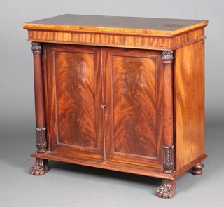 A Regency mahogany chiffonier, fitted a shelf enclosed by a pair of panelled doors, with turned columns to the sides, raised on paw feet 93cm h x 99cm w x 47cm d 