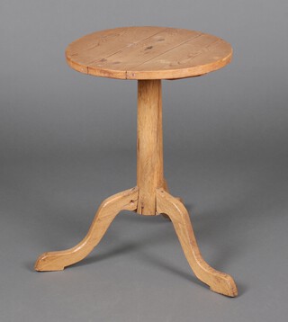 A 19th Century circular pine wine table, raised on a pillar and tripod base 60cm h x 45cm diam. 
